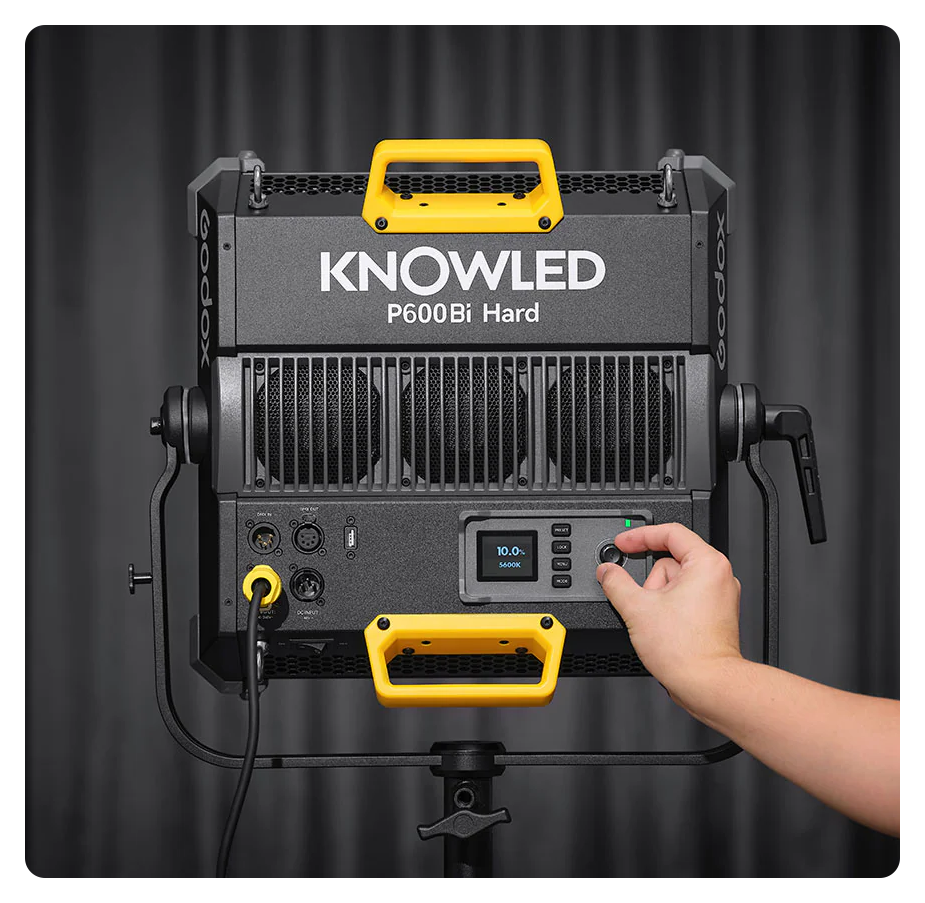 rear view of the godox p600bi led light with someone making small adjustments on the light