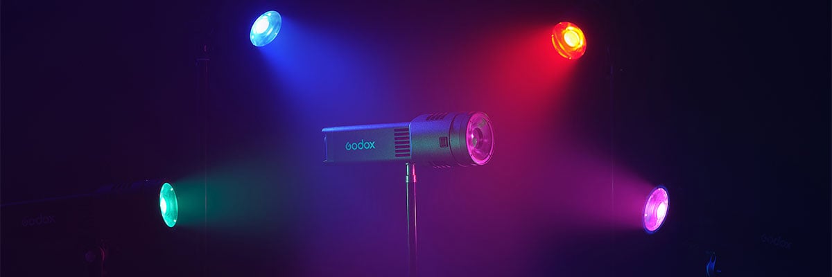 godox light in the center of a purple set lit with different colours