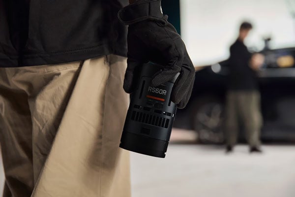 close up of someone holding the godox light in one hand