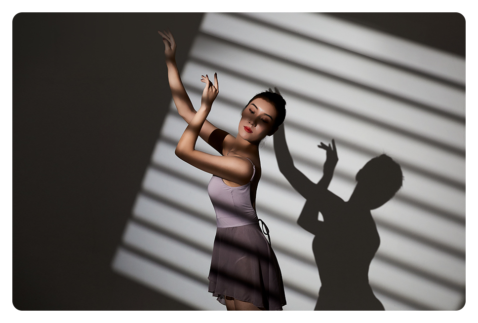 a woman under light shaped to look like stripes using the godox attachment kit