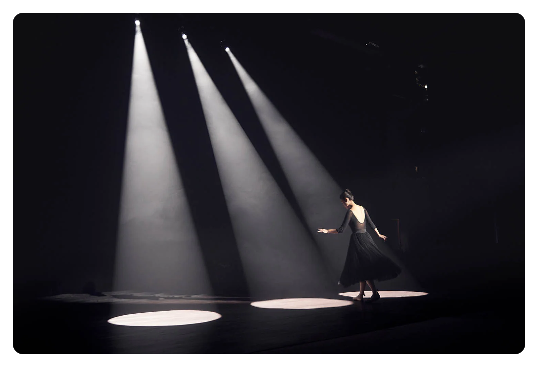 3 spotlights shining down on a dancer using the the godox attachment kit
