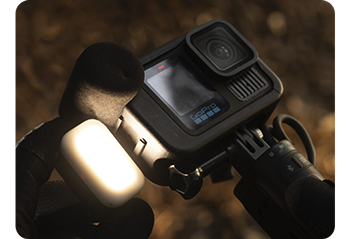close up image of GoPro HERO13 Black Creator Edition being held attaching LED Light Mod