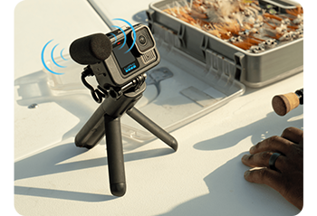 GoPro HERO13 Black Creator Edition standing on tripod with directional microphone set on table