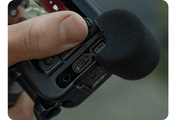 close up image of person holding GoPro Hero 13 black camera with ports open