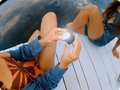 someone holding the gopro camera with the light on