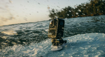 GoPro Hero Max2 mounted to surfboard being splashed in the ocean