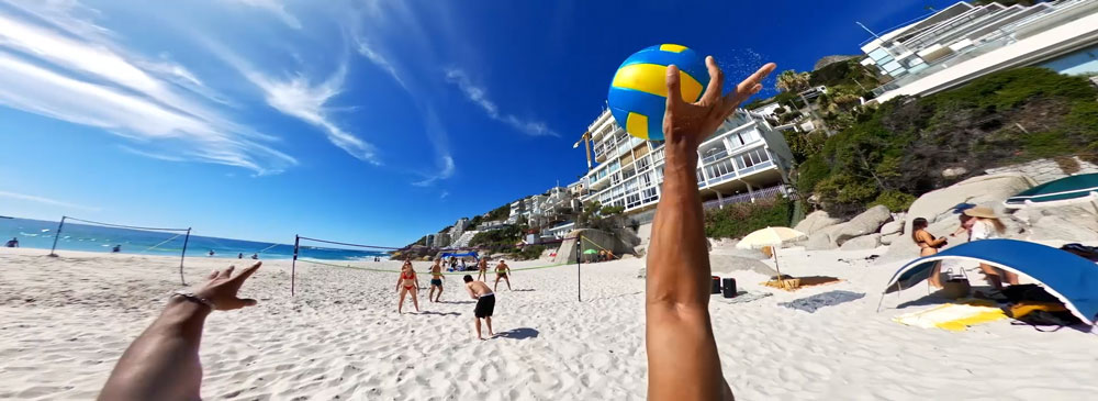 Wide angle view of people playing beach volleyball