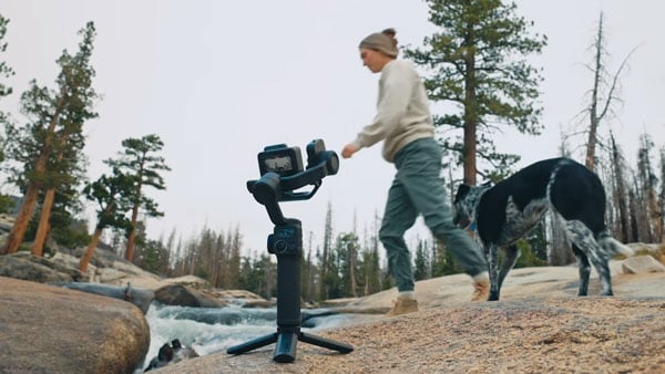 gopro mission 1 pro attached to a gimbal tracking a woman walking her dog