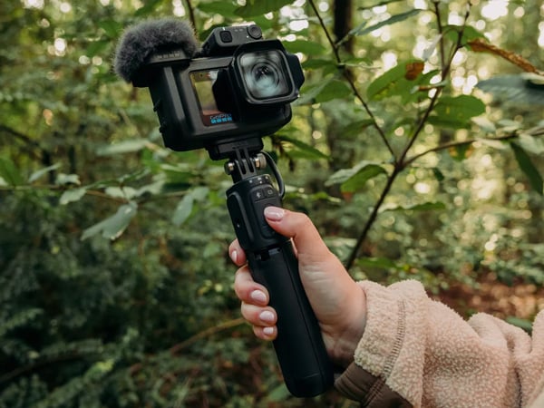 someone holding the gopro mission 1 pro connected the grip handle