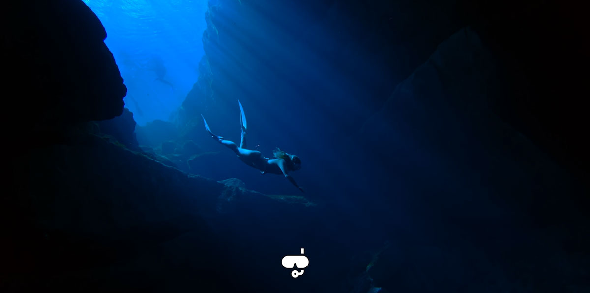 sample image of a diver going through a cave