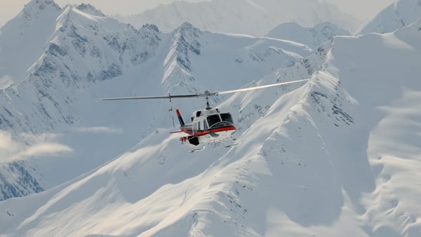 sample image of a helicopter flying over a snowy mountian