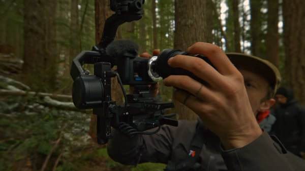 someone attaching a lens to the gopro mission 1 pro ils while it is mounted on a cable