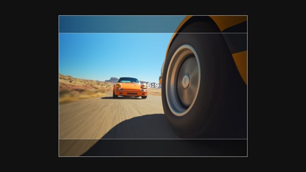 16:9 aspect ratio of two cars racing on a dirt road