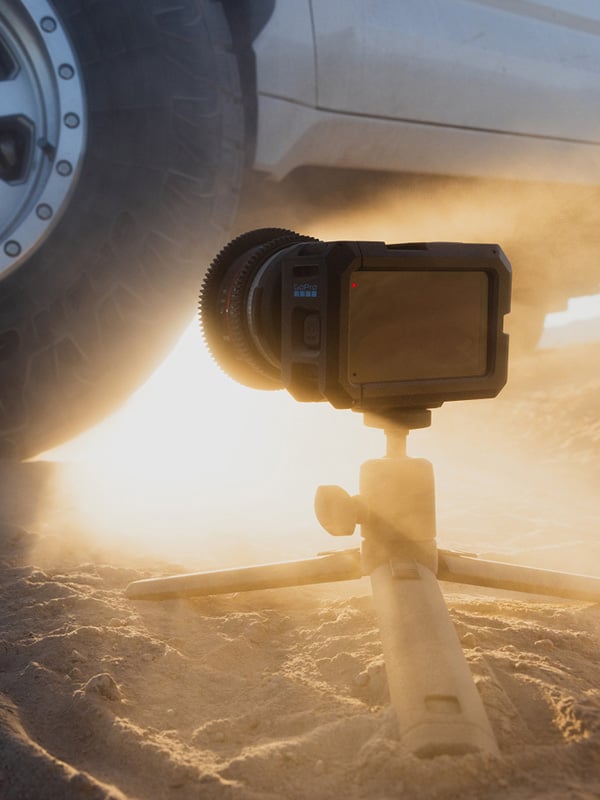 gopro mission1 pro ils on a tripod filming close to a car