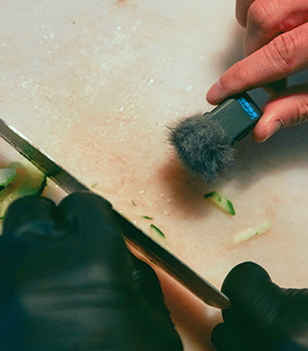 someone holding the gopro mic close to a chopping knife