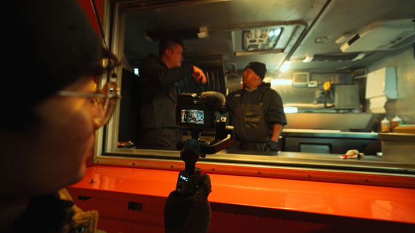 a man filming people in a food truck using the gopro wireless mic kit
