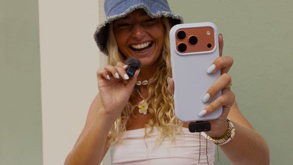 a woman using the gopro wireless mic connected to her phone