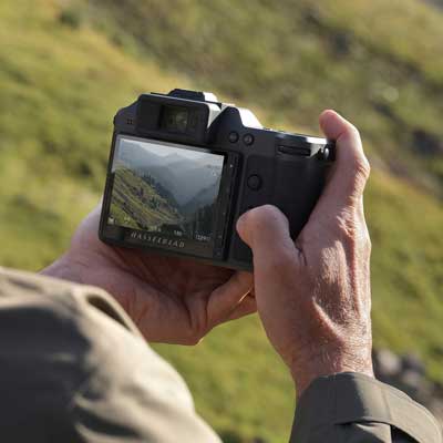 photographer holding Hasselblad X2D II 100C using rear control buttons