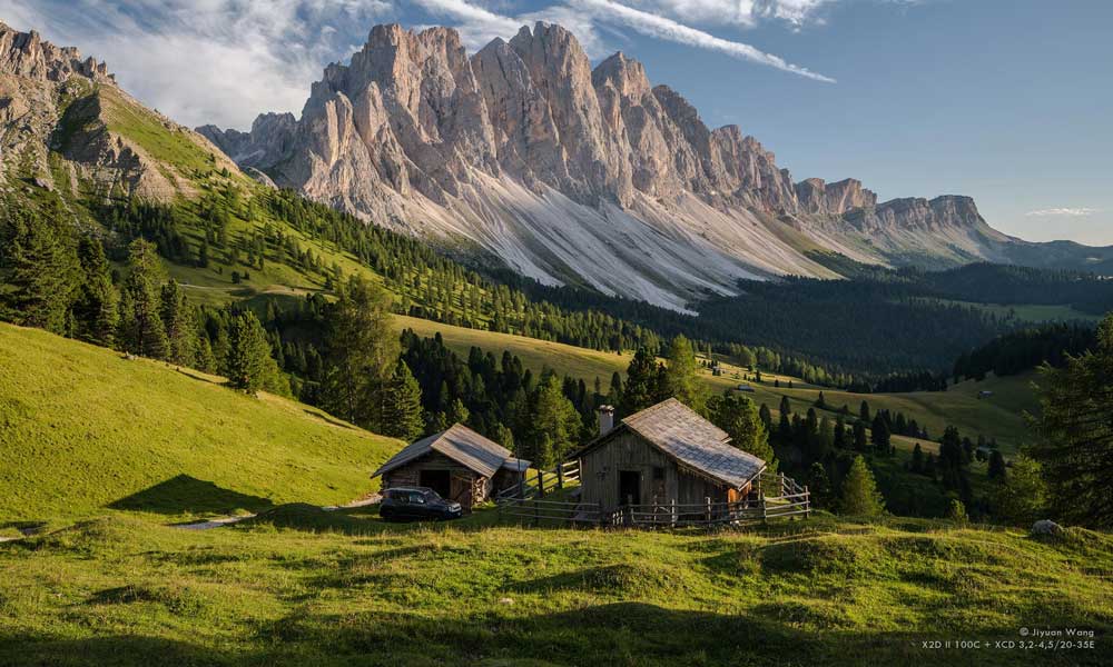 Hasselblad X2D II 100C Sample photograph of wooden cabin in swiss alps with mountain range in background