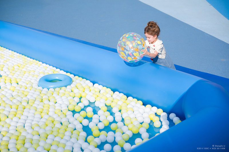 XCD 2.8-4/35-100E Sample image of young child throwing inflatable ball into ball pit