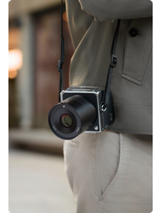 photographer carrying hasselblad 907x 100c with XCD 75p lens 
