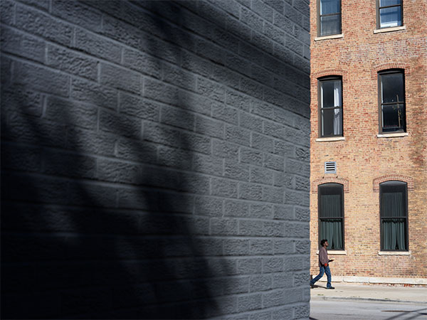Hasselblad XCD 75P Sample image of grey brick wall with contrasting red brick building in background