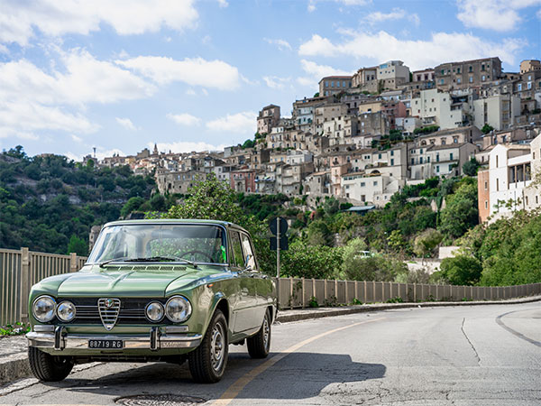Hasselblad XCD 75P Sample image of classic green alfa romeo parked at roadside with italian townscape in background