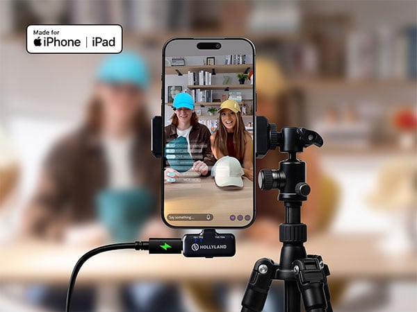 A smartphone setup on a tripod recording two content creators filming a vlog or live stream
