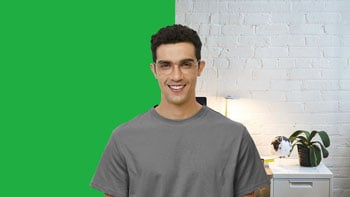 man standing infront of green screen with half background chromakeyed to be white office wall