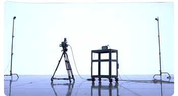 Camera mounted on tripod dolly infront of virtual production LED volume wall 