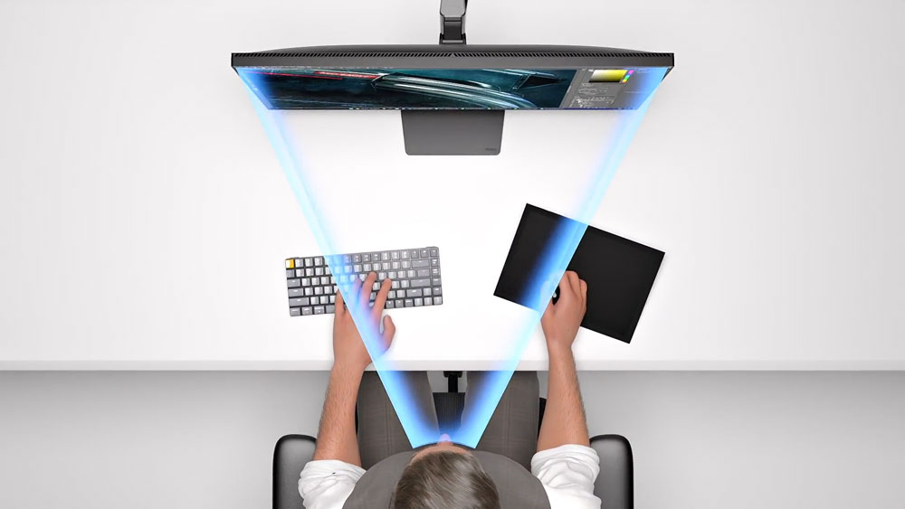 top down view of someone sat at a desk with the iiyama monitor showcasing the wide viewing angle