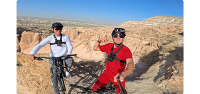 insta360 ace pro photograph of two men riding mountain bikes in the arizona desert with clear blue sky