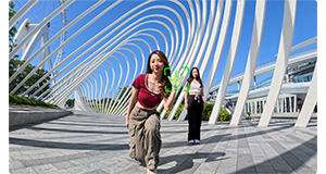 sample image of insta360 ace pro gesture controls with female dancers standing on modern architecture bridge