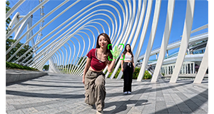 sample image of insta360 ace pro gesture controls with female dancers standing on modern architecture bridge