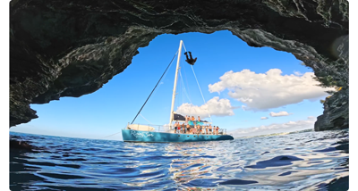 insta360 ace pro sample image of sailing boat at the mouth of a coastal cave with bright blue skies