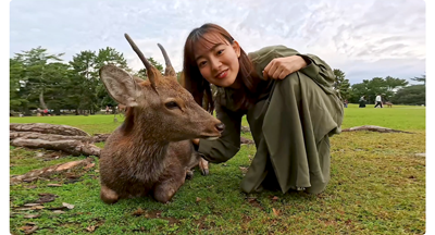 insta360 ace pro sample image of japanese woman kneeling with deer in Nara Park Japan
