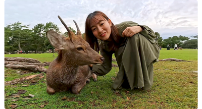 insta360 ace pro sample image of japanese woman kneeling with deer in Nara Park Japan