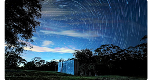 insat360 ace pro sample image of starlapse footage of barn under night sky with startrails