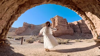 Sample HDR photograph of woman standing in desert cave opening