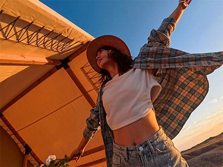 sample hdr photograph of woman dancing below peak of tent