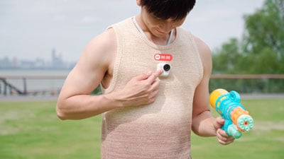 man wearing vest with insta360 GO Ultra magnetically mounted to chest strap