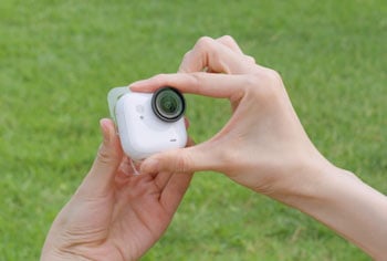 person attaching Insta360 Go Ultra to sticky tab
