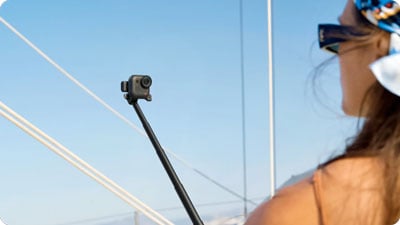 someone using the insta360 go ultra camera attached to the quick release mount