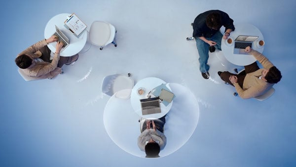top down view of someone at a table using the insta360 link 2 pro in a blue cafe