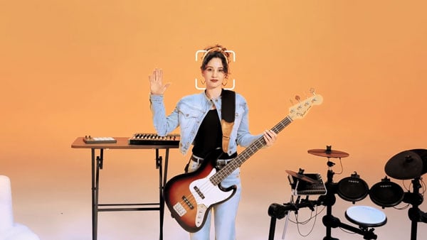someone holding their hand up in a orange music studio to control the insta360 link 2 pro
