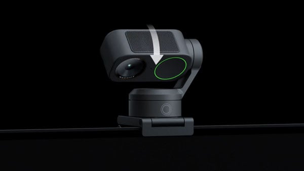 insta360 link 2 pro being turned downwards into privacy mode on a black background