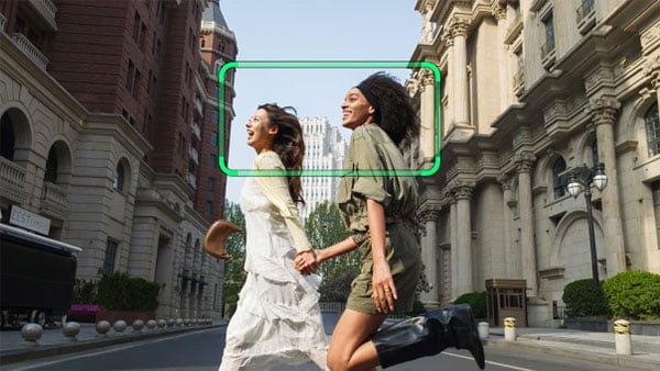 two women being tracked crossing a street
