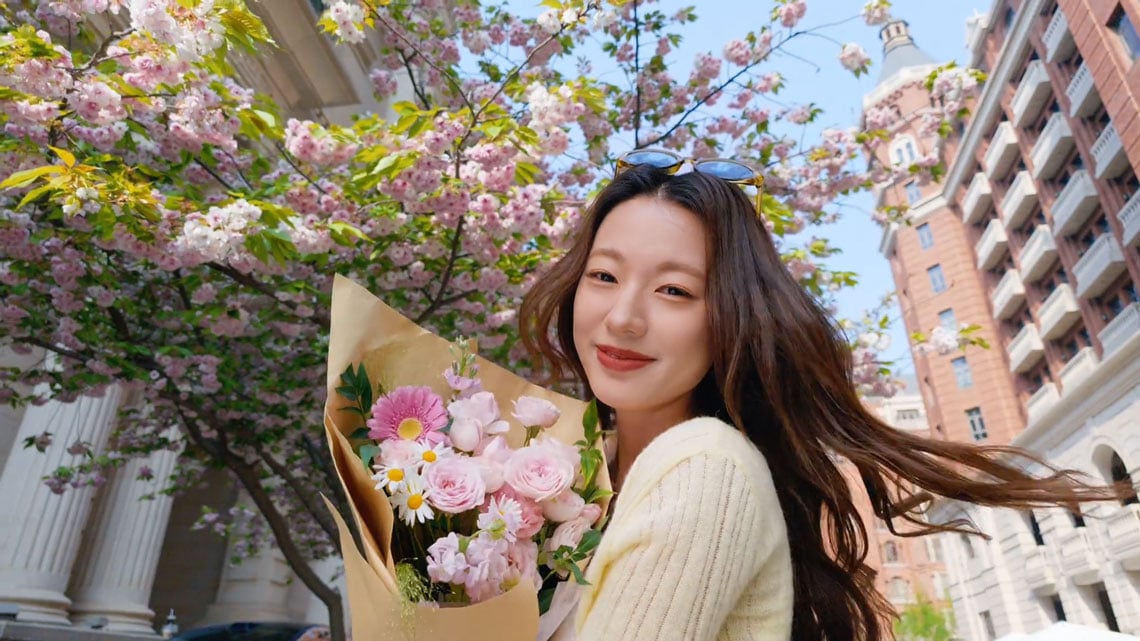example portrait of a woman holding pink flowers