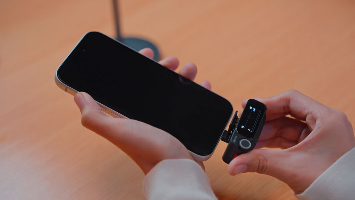 insta360 mic pro reciever being connected to the usb-c port on a smartphone