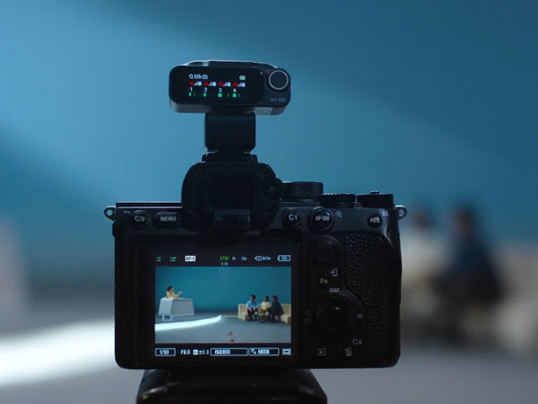 mic pro receiver on top of a camera while filming a multi-person interview